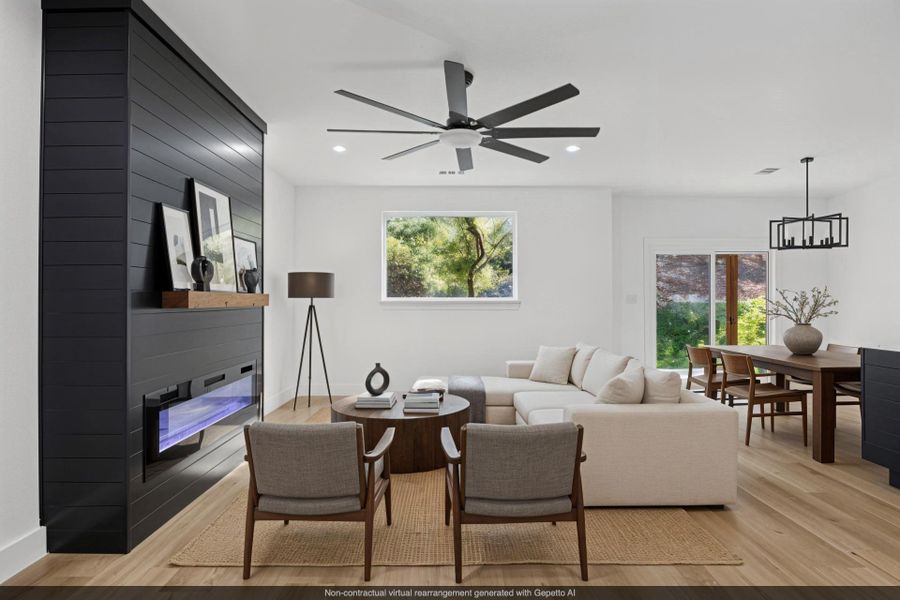 Virtually staged Living area with a glass covered fireplace, light wood-style floors, ceiling fan, recessed lighting, and a chandelier