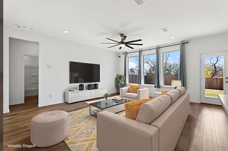 Living room featuring a ceiling fan, wood finished floors, and recessed lighting