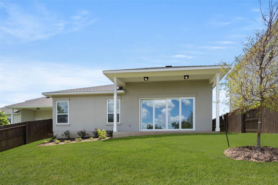 Rear view of house featuring stucco siding and roof with shingles
