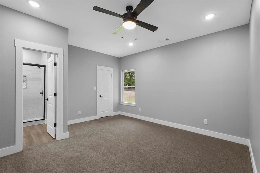 Unfurnished bedroom with ceiling fan and carpet flooring