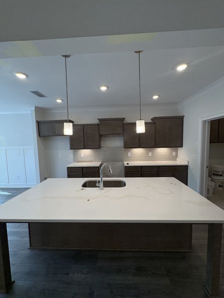 Kitchen with oversized island. Stainless steel Kitchen appliances with Gas Stove to be installed.