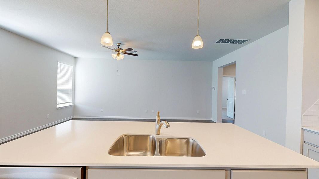 Open concept living area with a ceiling fan, window with blinds, and recessed lighting