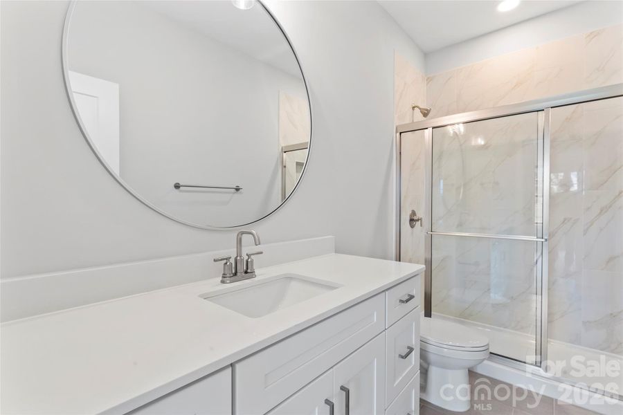 Main floor ensuite bedroom with walk-in shower. Main floor ensuite bedroom with walk-in shower.