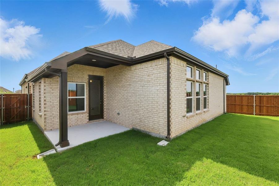 Rear view of house featuring brick siding and a patio area Rear view of house featuring brick siding and a patio area