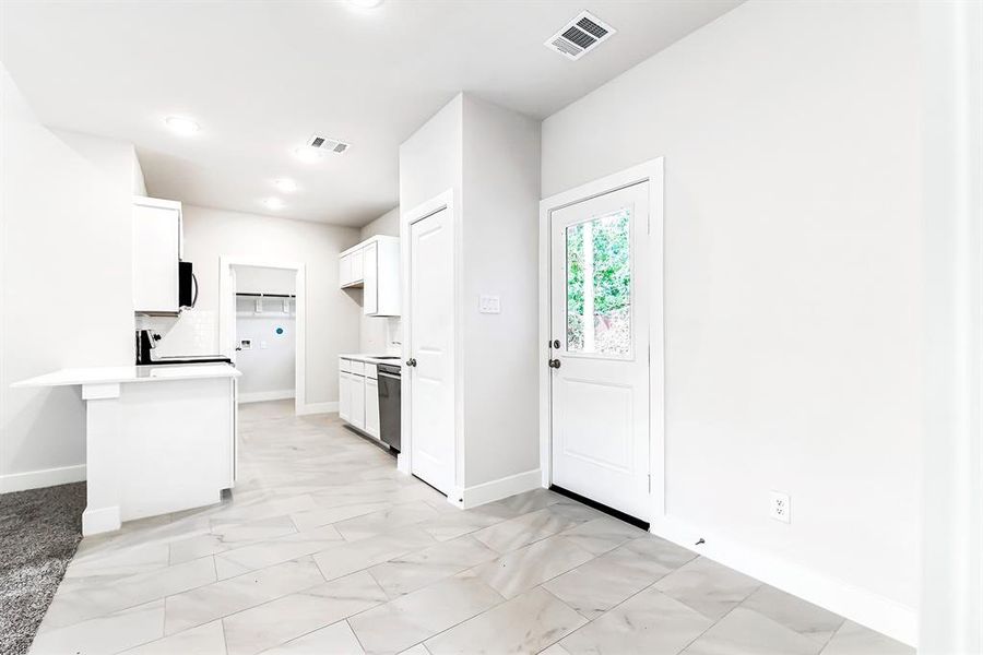 View from dining area through kitchen to laundry room.