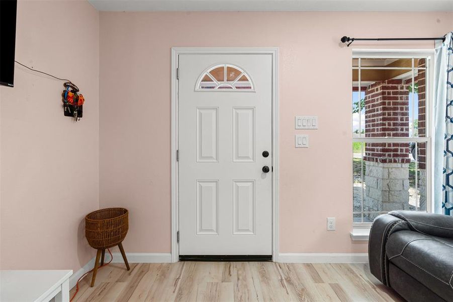 Foyer featuring light wood finished floors and baseboards Foyer featuring light wood finished floors and baseboards
