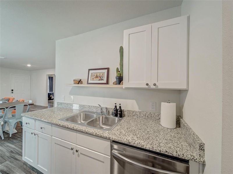 Kitchen featuring white cabinets, dishwasher, dark wood finished floors, open shelves, and recessed lighting