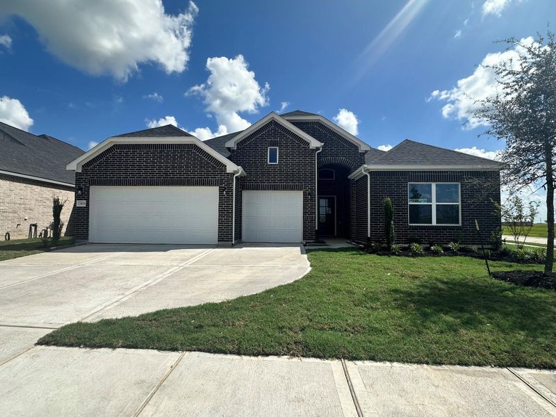 Front exterior of a new home in Creekhaven, Iowa Colony, TX, highlighting curb appeal (Image 21).