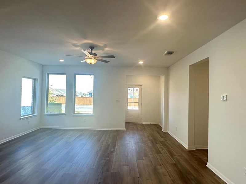Empty room with dark wood-type flooring, recessed lighting, and ceiling fan Empty room with dark wood-type flooring, recessed lighting, and ceiling fan