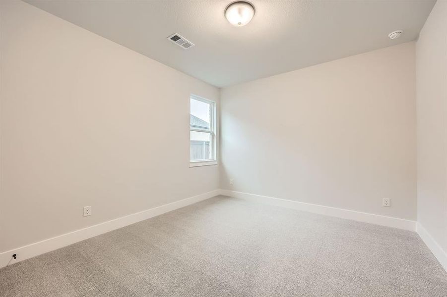 Spare room featuring carpet flooring