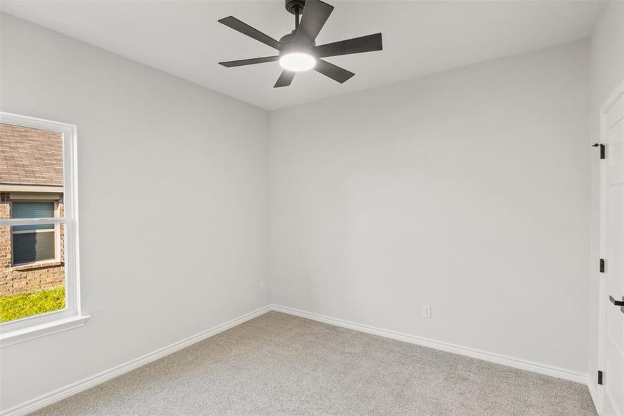 Spare room with carpet flooring and a ceiling fan