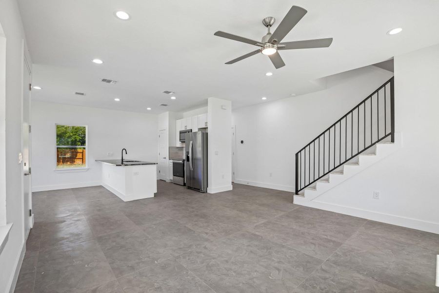 An open main-level layout pairs durable tile flooring with clean white walls and modern design.
