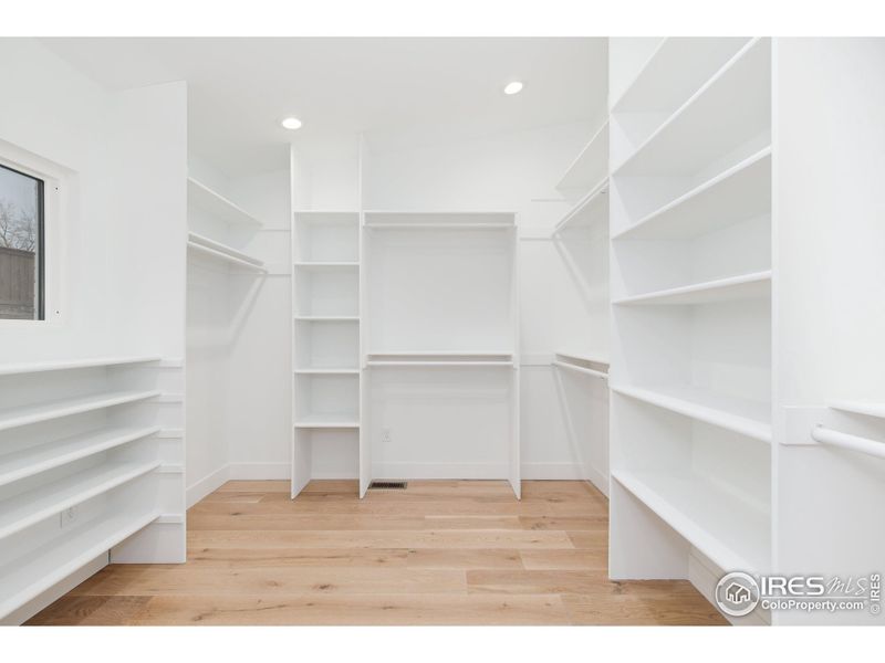 Primary bedroom custom walk-in closet by California Closets, with Wash/Dryer Hookup.