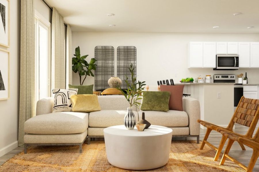 A living room with a white couch and a white table.