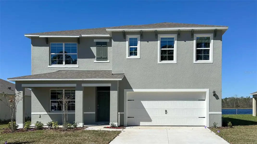 Front exterior of a new home in Buena Lago, St. Cloud, FL, highlighting curb appeal (Image 2).