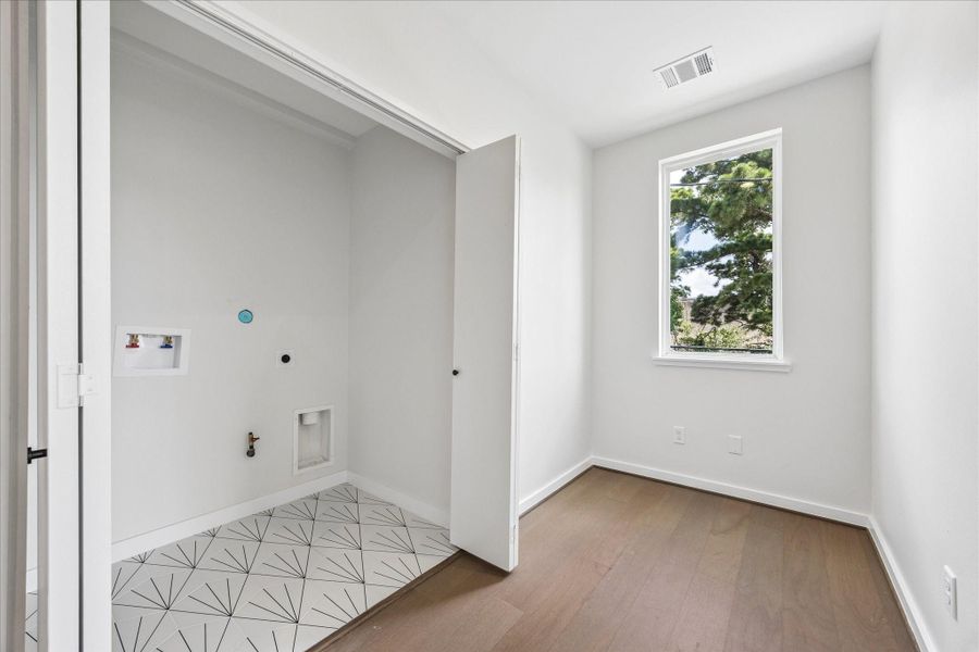 Dedicated utility room with laundry connections, a utility sink, and space for additional storage or organization. Dedicated utility room with laundry connections, a utility sink, and space for additional storage or organization.