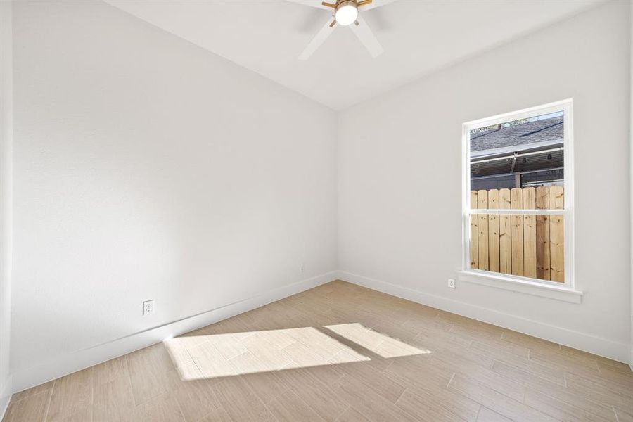 Unfurnished room featuring light wood-style flooring and a ceiling fan