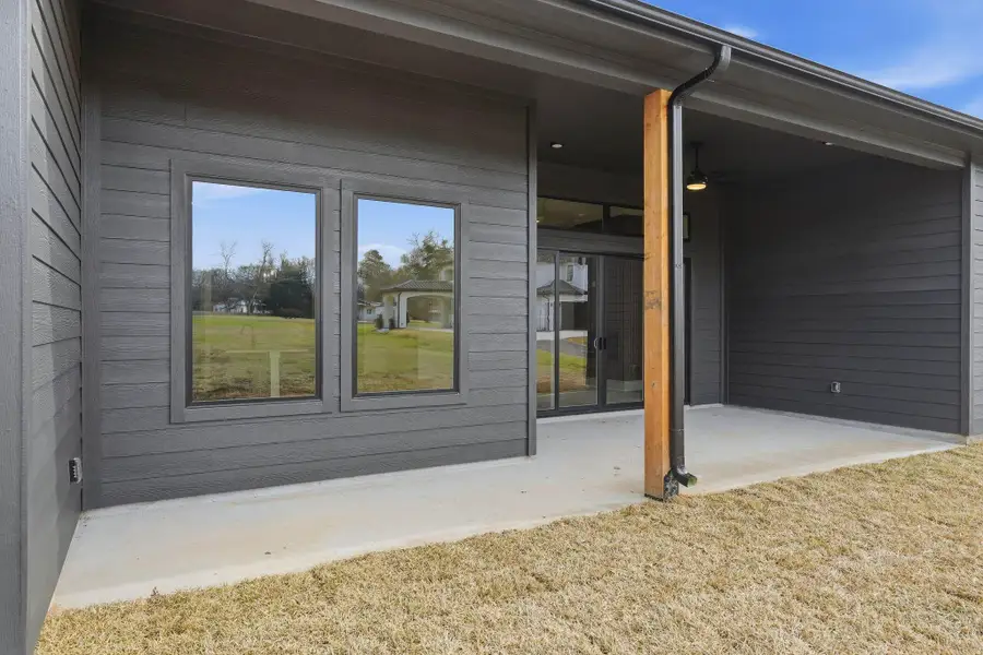 Large windows that bring in natural light and connect indoor living to outdoor space.