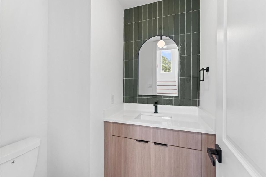 Raised powder room with chic minimalistic finishes Raised powder room with chic minimalistic finishes