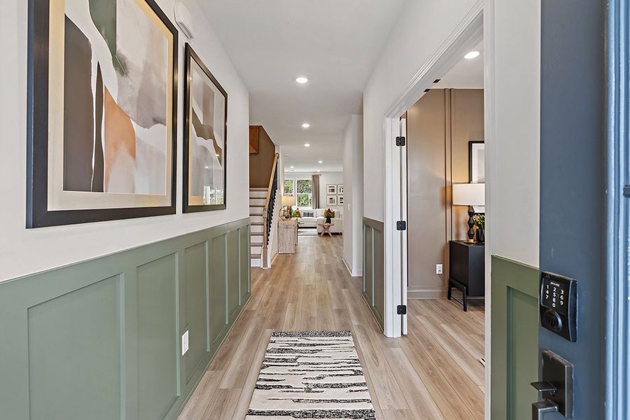 A long hallway with a wood floor. A long hallway with a wood floor.