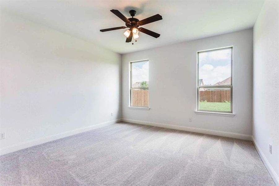 Spare room featuring ceiling fan and carpet flooring