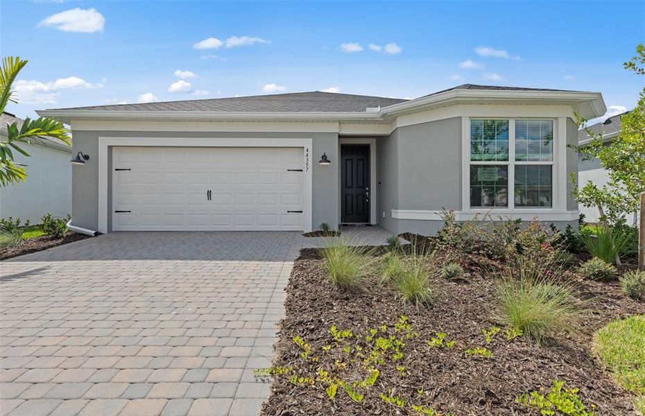 Front exterior of a new home in Reagan Landing, Bradenton, FL, highlighting curb appeal (Image 2). Front exterior of a new home in Reagan Landing, Bradenton, FL, highlighting curb appeal (Image 2).