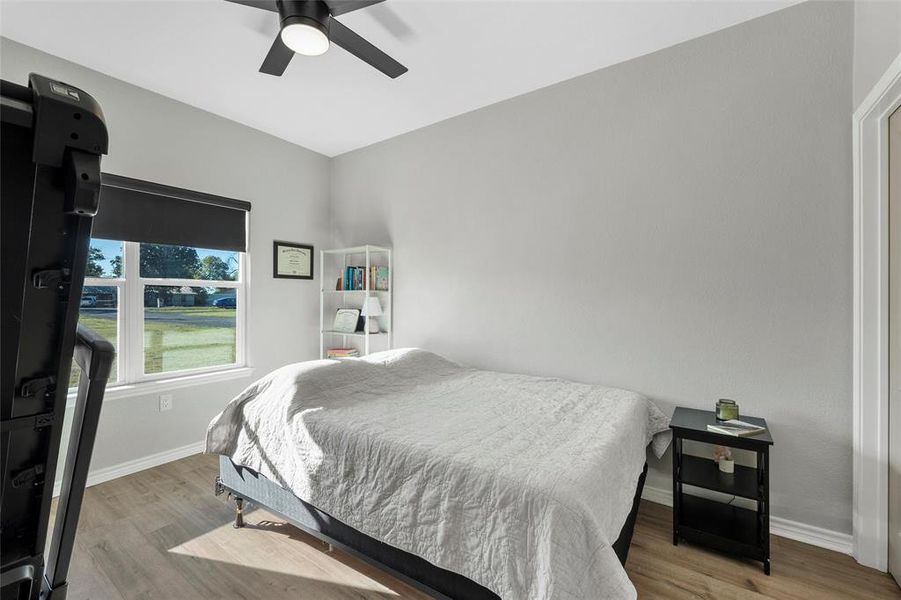 Bedroom with wood finished floors and a ceiling fan
