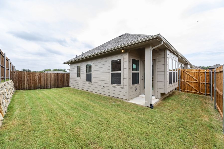 Exterior details and patio area of a home in Keeneland, Aubrey (Image 4).