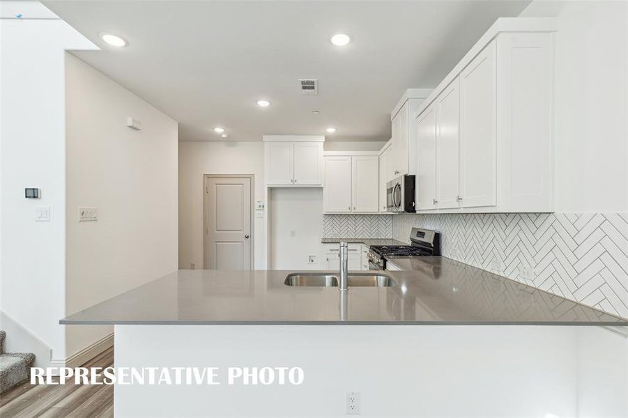 The kitchen peninsula, featuring a breakfast bar, is the perfect place for a quick meal or homework station.  REPRESENTATIVE PHOTO