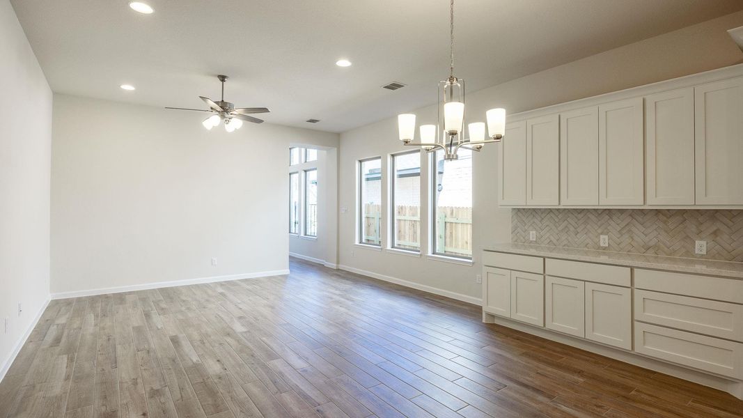 Unfurnished dining area with recessed lighting, light wood-type flooring, and baseboards