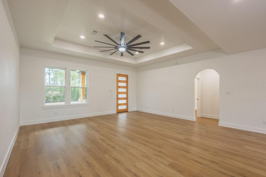 Step into a bright and expansive open-concept living area featuring rich wood-style flooring, recessed lighting, and an eye-catching statement ceiling fan. The layout effortlessly flows into the kitchen, creating an ideal space for both relaxing and entertaining. Step into a bright and expansive open-concept living area featuring rich wood-style flooring, recessed lighting, and an eye-catching statement ceiling fan. The layout effortlessly flows into the kitchen, creating an ideal space for both relaxing and entertaining.