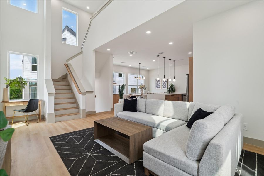 A masterclass in modern proportion—this living room balances vertical space with grounded textures and clean lines.