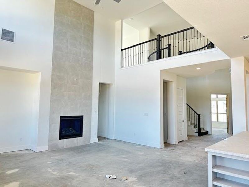 Family Room with soaring ceiling & fireplace