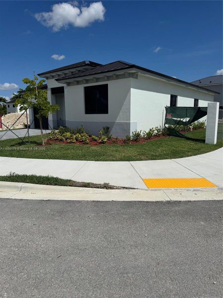Front exterior of a new home in , Homestead, FL, highlighting curb appeal (Image 2). Front exterior of a new home in , Homestead, FL, highlighting curb appeal (Image 2).