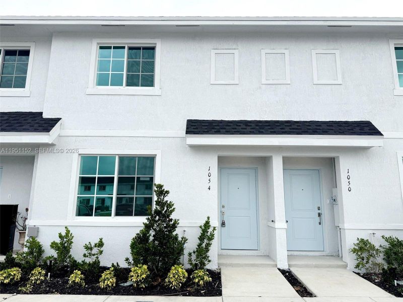 Front exterior of a new home in , Florida City, FL, highlighting curb appeal (Image 1). Front exterior of a new home in , Florida City, FL, highlighting curb appeal (Image 1).
