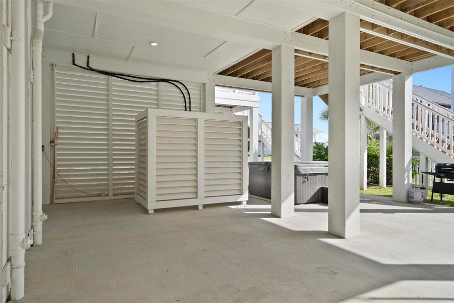 Discreetly positioned beneath the elevated structure, this enclosed utility space offers secure, weather-protected access to essential systems—engineered for durability, longevity, and ease of maintenance, all while preserving the home’s clean coastal aesthetic. Discreetly positioned beneath the elevated structure, this enclosed utility space offers secure, weather-protected access to essential systems—engineered for durability, longevity, and ease of maintenance, all while preserving the home’s clean coastal aesthetic.