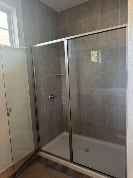 Full bathroom featuring a shower stall Full bathroom featuring a shower stall
