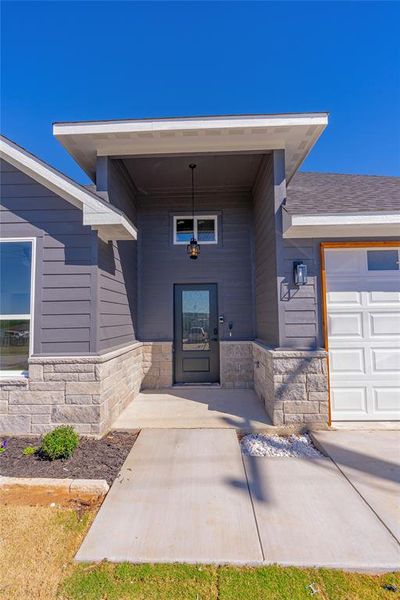 View of exterior entry featuring a garage