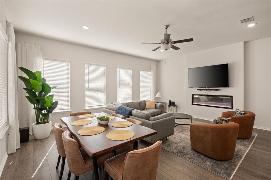 Dining space with dark hardwood / wood-style floors and ceiling fan