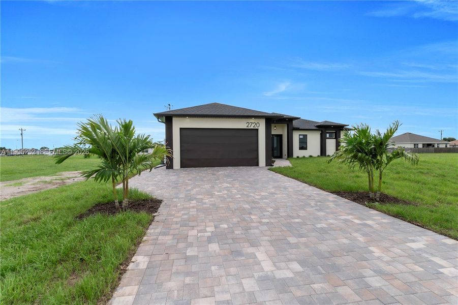 Front exterior of a new home in , Cape Coral, FL, highlighting curb appeal (Image 24).