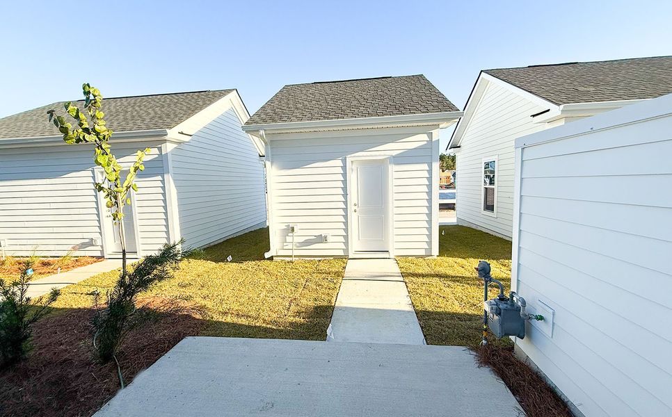 Exterior details and patio area of a home in Townhomes at Nexton, Summerville (Image 3).
