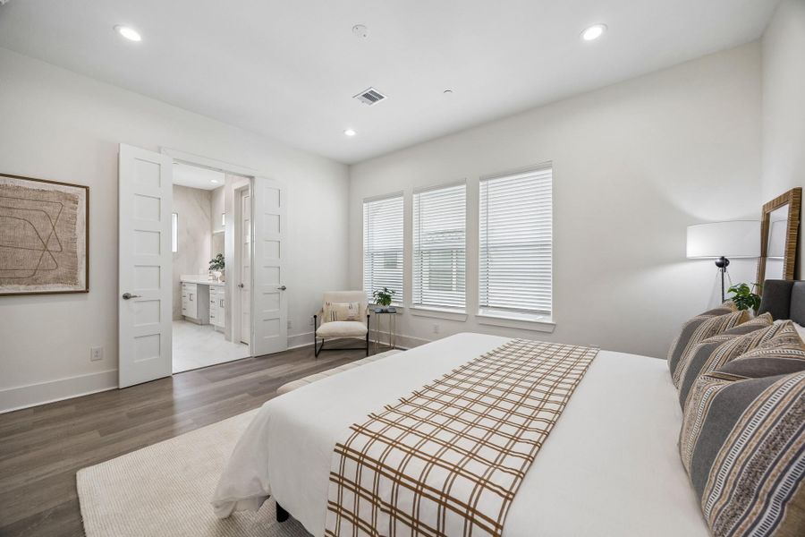 Double doors lead to the primary bedroom's ensuite bath. Double doors lead to the primary bedroom's ensuite bath.