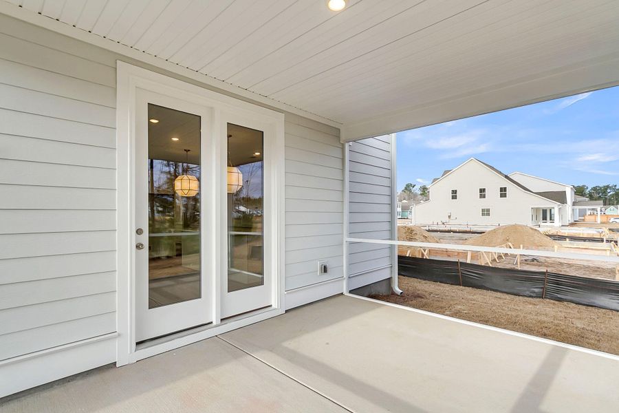 Exterior details and patio area of a home in Tidewater at Lakes of Cane Bay, Summerville (Image 25).