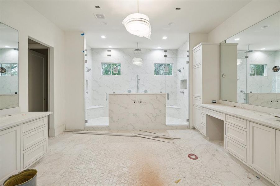 Large Primary Bathroom with dual counters, vanity, freestanding tub, large walk-in shower with two frameless doors, lined storage and more.....  Absolutely gorgeous tile work!  Construction as of Jan. 13th, 2025.