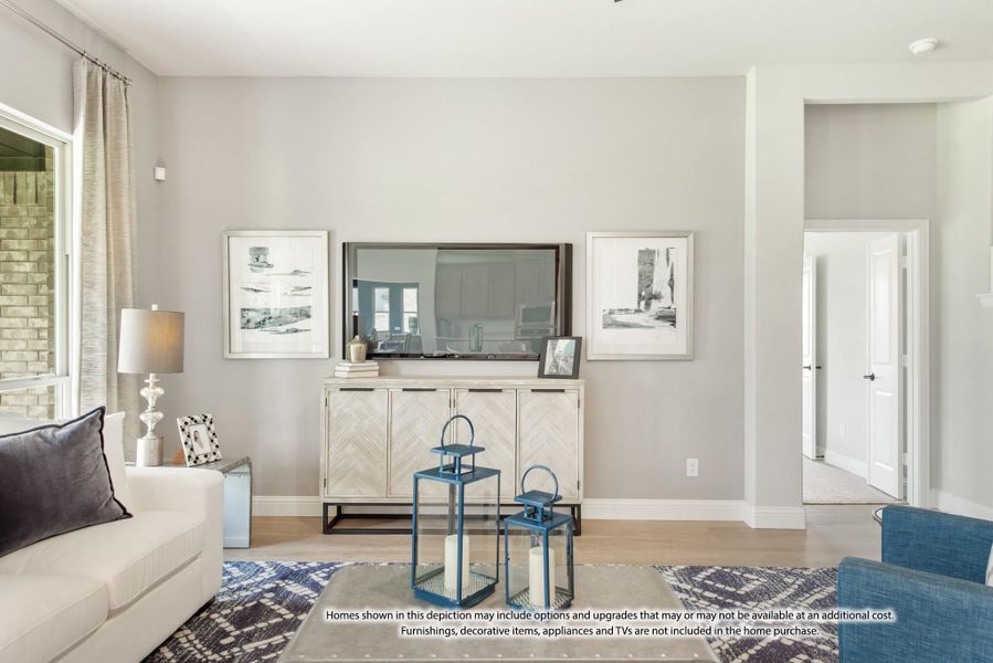 Living room with gray walls, white sofa, wall-mounted TV, and blue decorative lanterns on hardwood floors Living room with gray walls, white sofa, wall-mounted TV, and blue decorative lanterns on hardwood floors