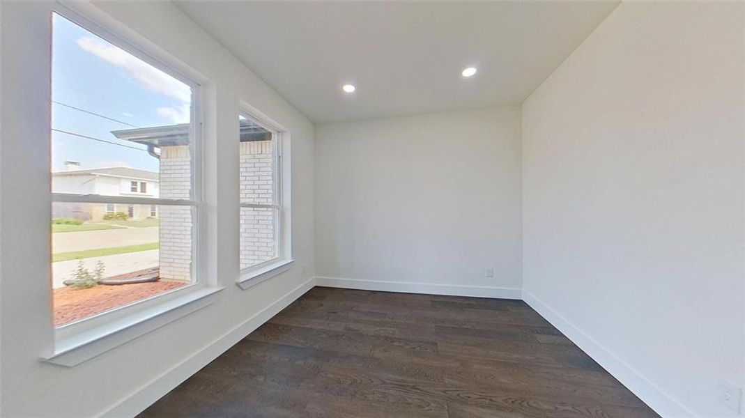 Spare room featuring dark wood finished floors and recessed lighting
