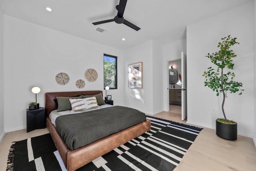 Primary Suite featuring white oak floors, ensuite bathroom, a ceiling fan, and recessed lighting Primary Suite featuring white oak floors, ensuite bathroom, a ceiling fan, and recessed lighting