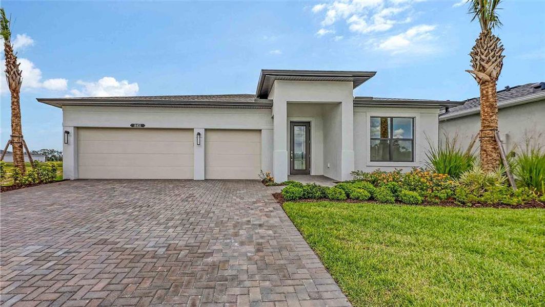 Front exterior of a new home in Woodland Preserve, Parrish, FL, highlighting curb appeal (Image 2).