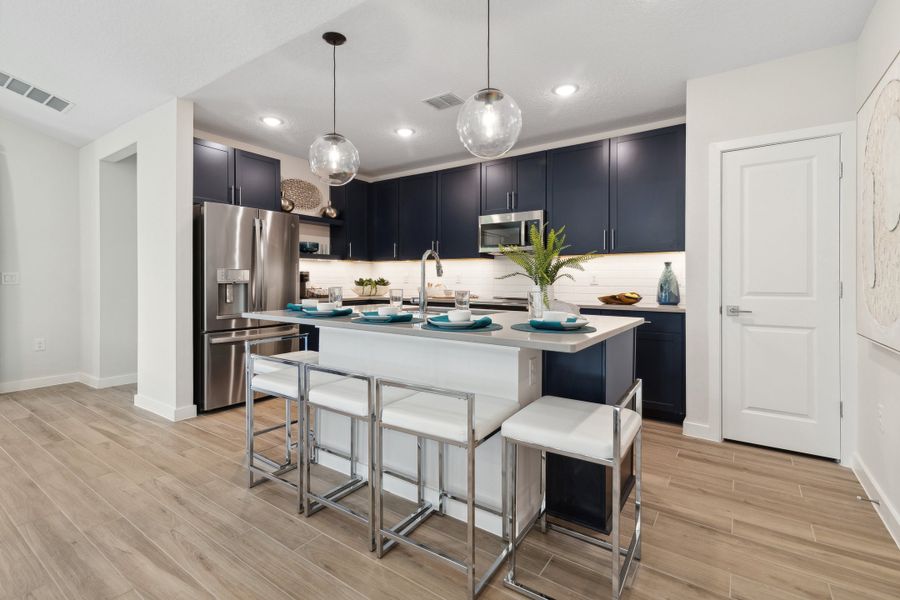 Kitchen with pendant lighting and floating shelves