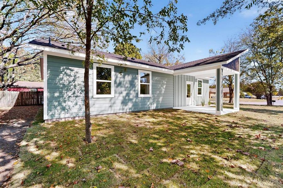 Rear view of property featuring a patio area and board and batten siding Rear view of property featuring a patio area and board and batten siding